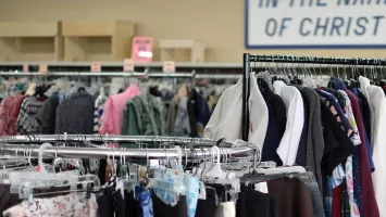 Clothes hanging on racks in the Winkler MCC Thrift shop.