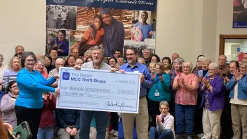 Staff and volunteers at The Depot thrift shop presenting a $1 million check.